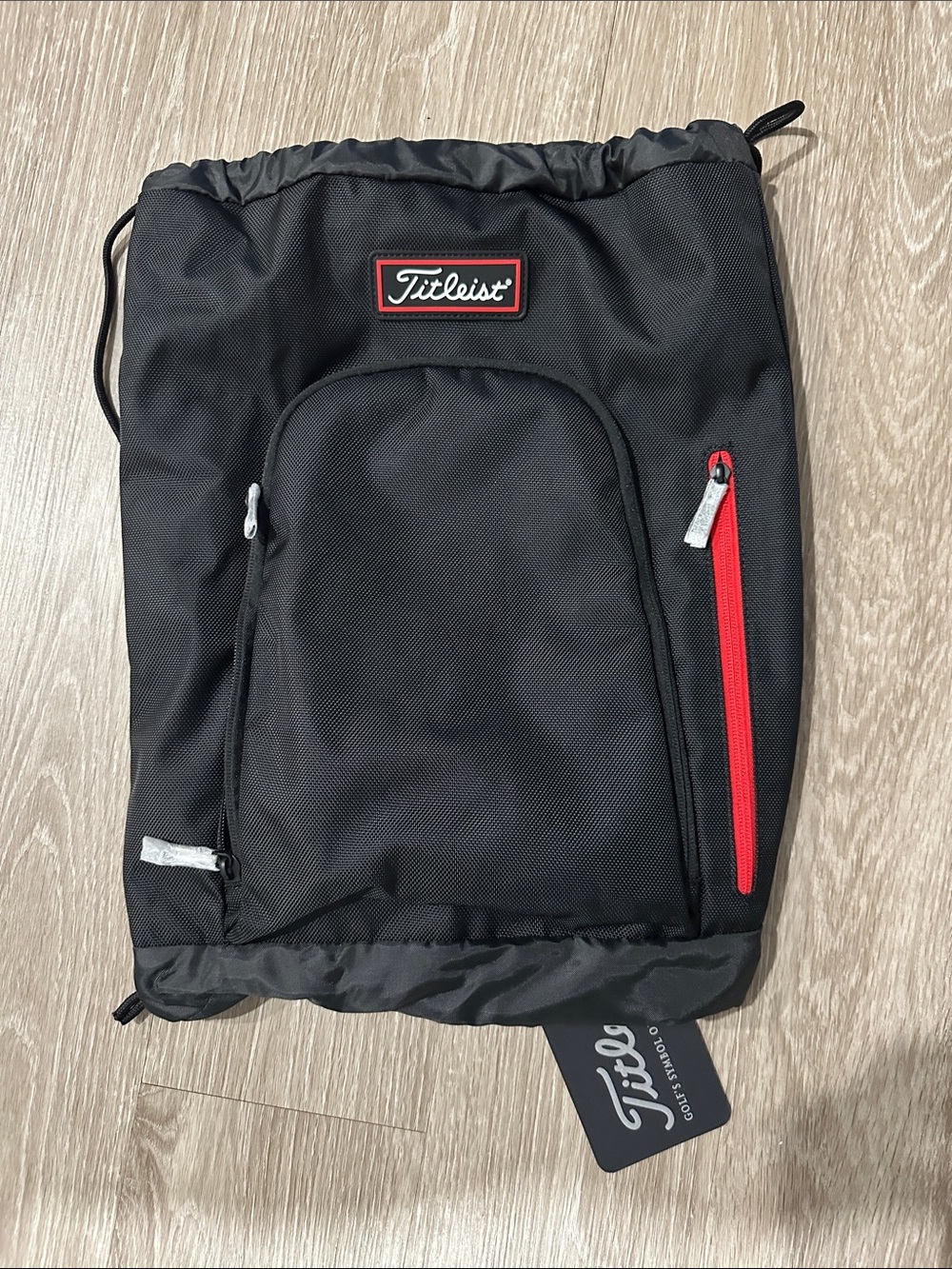 Titleist Black Drawstring Backpack with Red Zip Accents